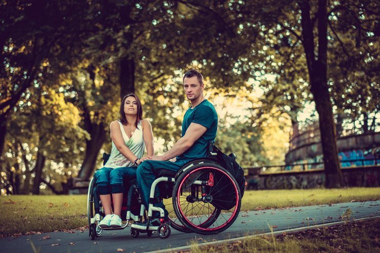 handicapped-young-couple-two-wheelchairs-kissing-autumn-park_613910-15228